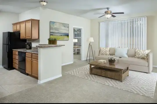 living room featuring carpet, natural light, a ceiling fan, refrigerator, and dishwasher