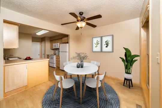 hardwood floored dining space featuring a ceiling fan, range oven, refrigerator, and microwave