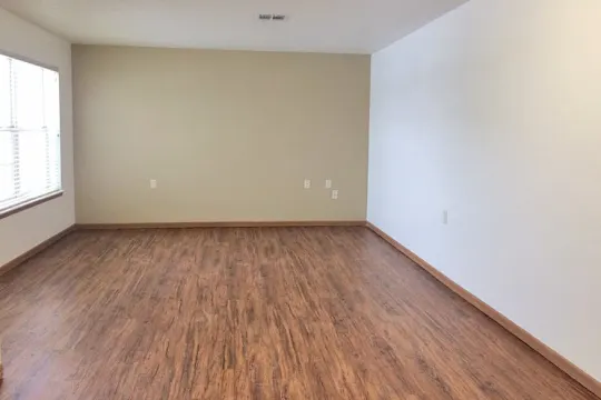 spare room featuring hardwood flooring and natural light
