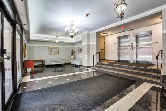 lobby featuring a chandelier and an elevator