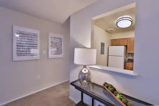 hallway with carpet and refrigerator