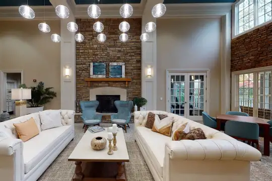 living room with natural light, a high ceiling, and a fireplace