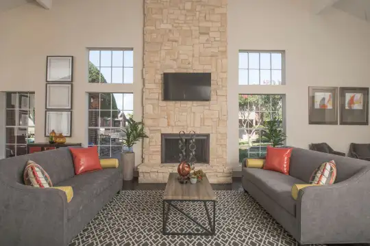 living room with a high ceiling, a fireplace, plenty of natural light, and TV