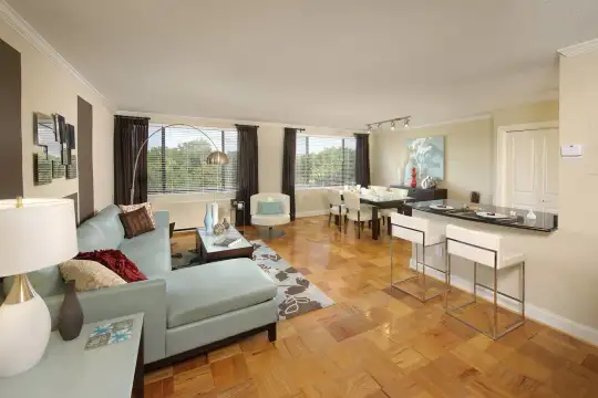 living room featuring a wealth of natural light, parquet floors, and a breakfast bar area