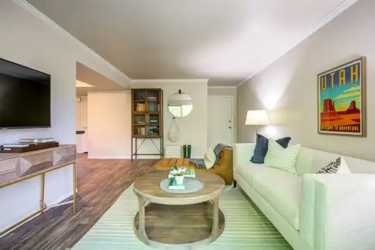 hardwood floored living room featuring TV