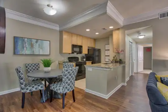 dining area featuring a center island, hardwood flooring, range oven, refrigerator, and microwave