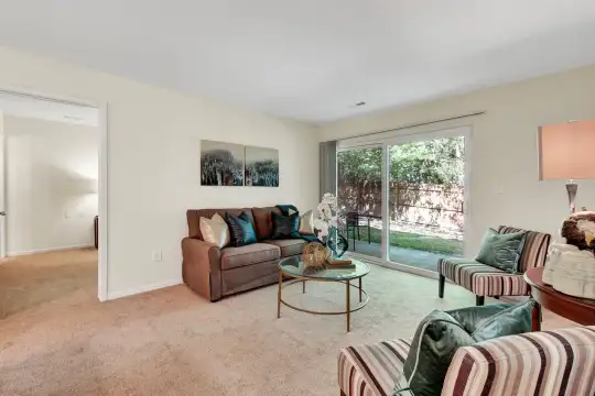 living room featuring carpet and natural light