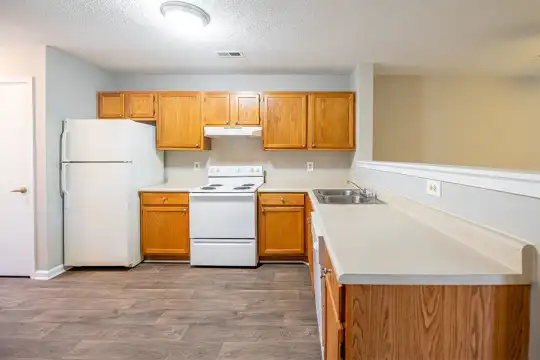 kitchen featuring refrigerator, electric range oven, extractor fan, light tile flooring, brown cabinets, and light countertops