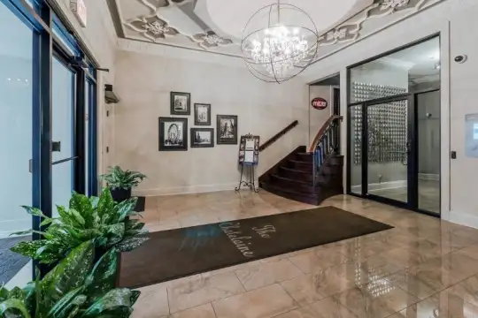 lobby with a notable chandelier and tile floors