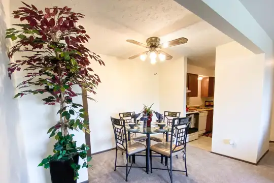 carpeted dining space with a ceiling fan