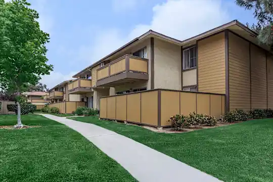 back of property featuring a large lawn