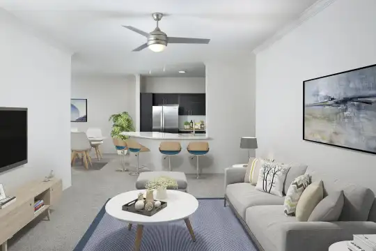 living room featuring a ceiling fan, a breakfast bar, refrigerator, and TV