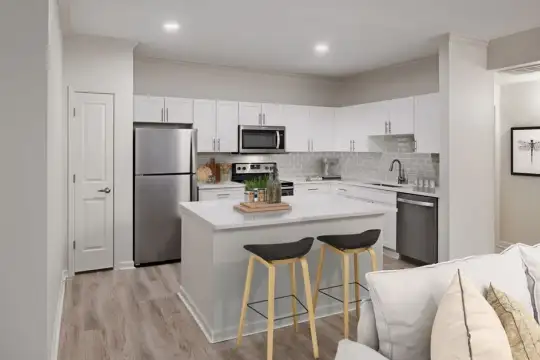 kitchen with stainless steel appliances, range oven, light countertops, white cabinetry, and light parquet floors