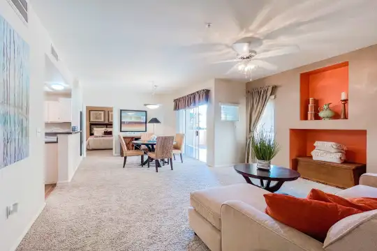 living room with a ceiling fan and carpet