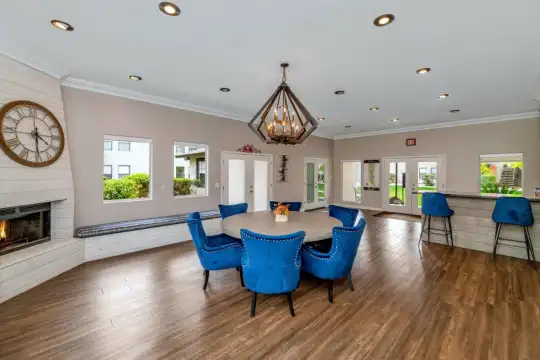 dining area with a healthy amount of sunlight, hardwood floors, and a fireplace