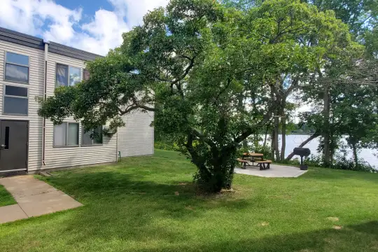 yard featuring a water view and an expansive lawn