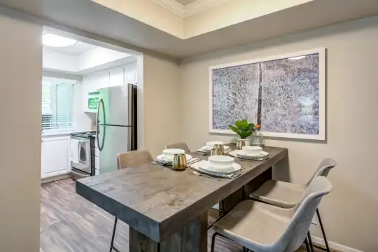 dining area featuring a healthy amount of sunlight, hardwood flooring, refrigerator, and range oven