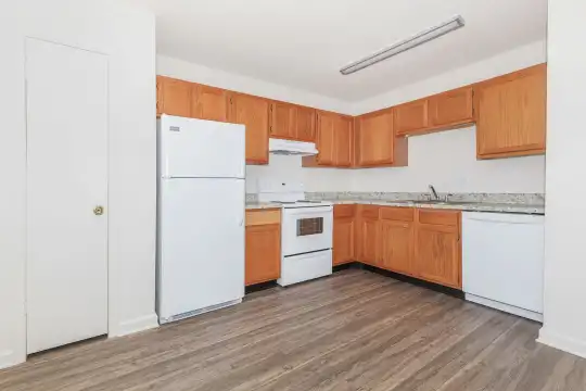 kitchen with range hood, refrigerator, electric range oven, dishwasher, light countertops, dark hardwood flooring, and brown cabinetry