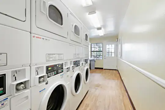 washroom featuring hardwood flooring and separate washer and dryer
