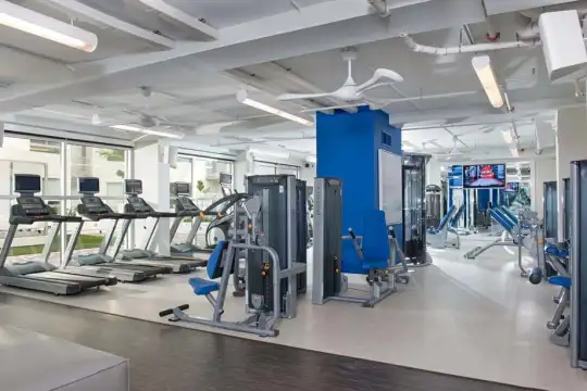 gym with wood beam ceiling and TV