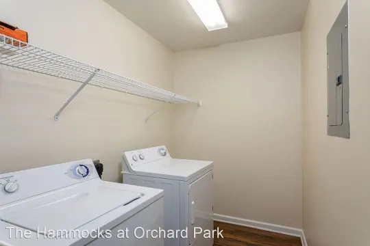 washroom with hardwood flooring and independent washer and dryer
