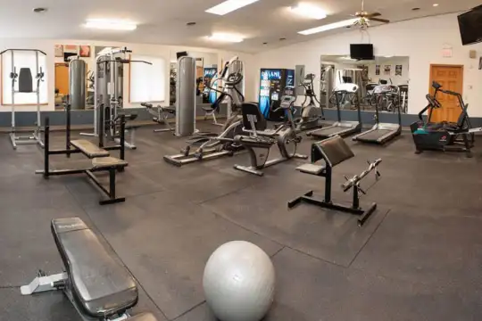 gym featuring tile flooring and TV