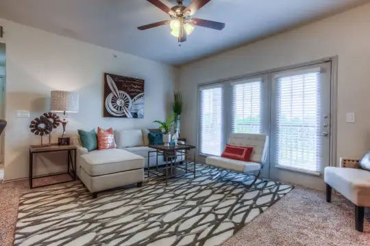 living room with a healthy amount of sunlight and a ceiling fan