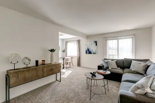 carpeted living room with a healthy amount of sunlight