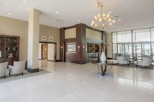 lobby featuring a notable chandelier, tile floors, and natural light