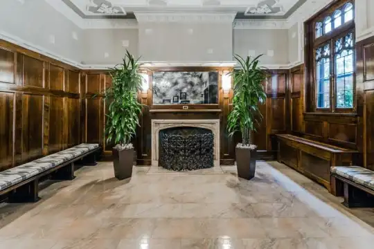 lobby with a fireplace, natural light, and tile floors
