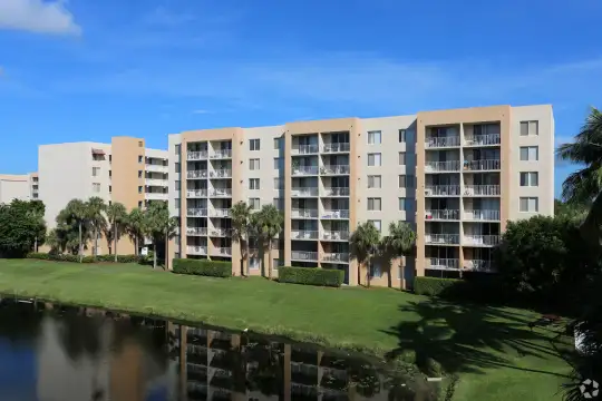 view of building exterior featuring a lawn and a water view