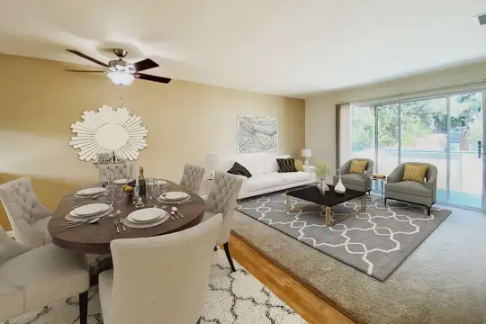 dining space featuring carpet, natural light, and a ceiling fan