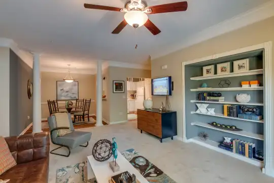 living area with carpet and a ceiling fan