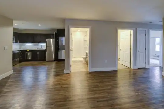 hardwood floored living room featuring refrigerator