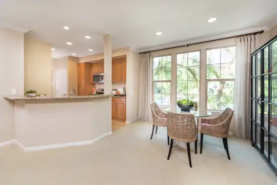 dining area featuring carpet, natural light, and microwave