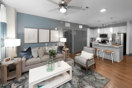 living room featuring a ceiling fan, stainless steel refrigerator, range oven, and microwave