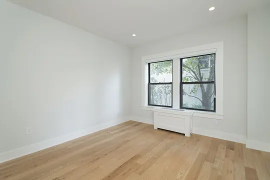 empty room featuring parquet floors and natural light