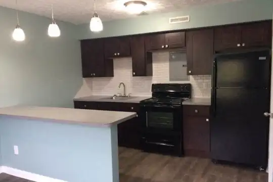 kitchen featuring refrigerator, electric range oven, dark brown cabinetry, pendant lighting, light stone countertops, and dark hardwood floors