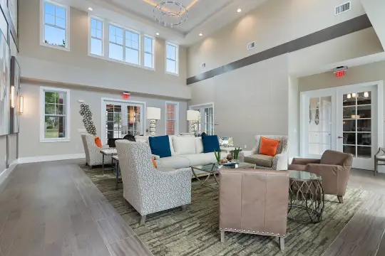 community lobby featuring a high ceiling, french doors, and parquet floors