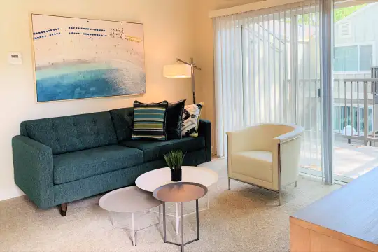 living room featuring carpet and abundant sunlight