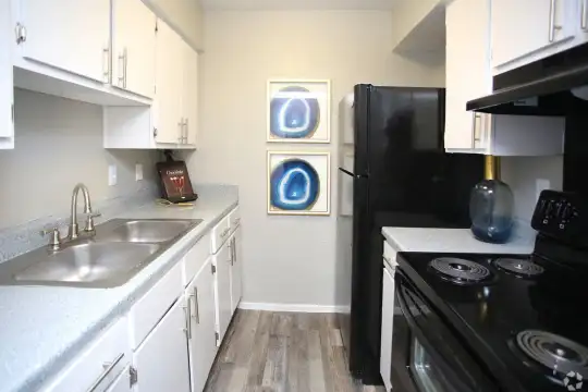 kitchen with ventilation hood, refrigerator, white cabinets, light countertops, and light parquet floors