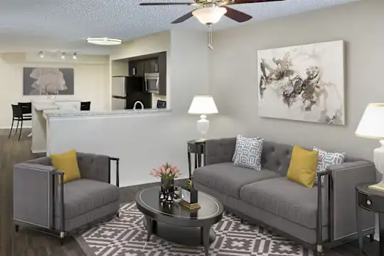 living room featuring a kitchen bar, a ceiling fan, refrigerator, and microwave