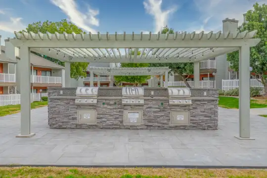view of nearby features featuring a yard, a pergola, and an outdoor kitchen