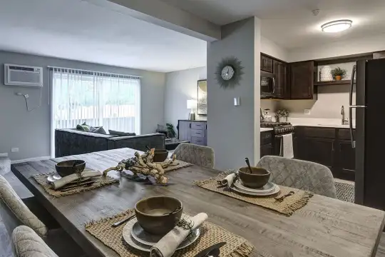 dining area with natural light, refrigerator, gas range oven, and microwave