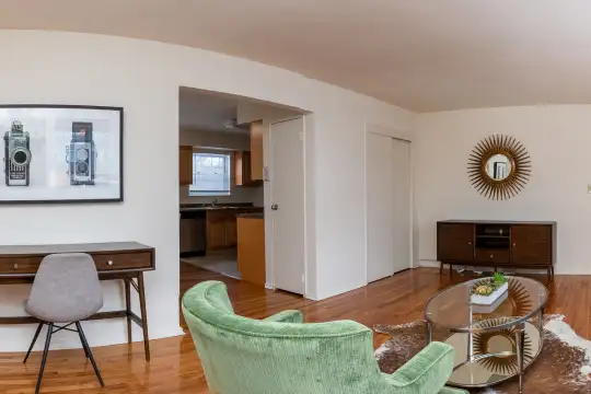 living room with hardwood floors, natural light, and dishwasher