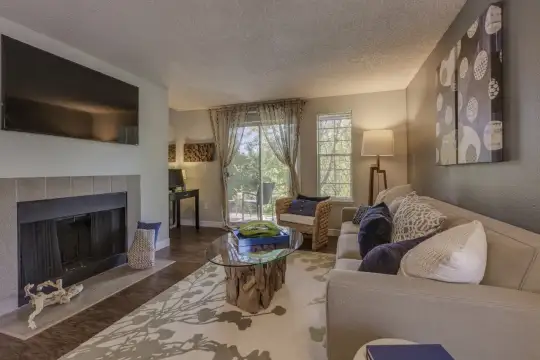 living room featuring a fireplace, hardwood flooring, a healthy amount of sunlight, and TV