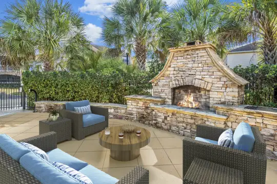 view of terrace with an outdoor fireplace