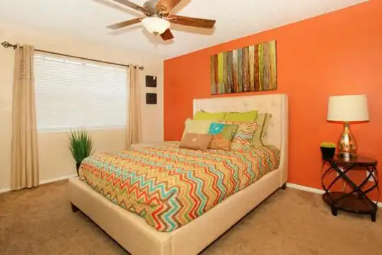 bedroom with carpet, natural light, and a ceiling fan