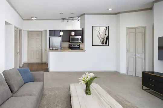 living room with carpet, stainless steel refrigerator, TV, range oven, and microwave