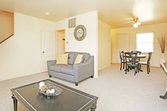 carpeted living room with natural light and a ceiling fan